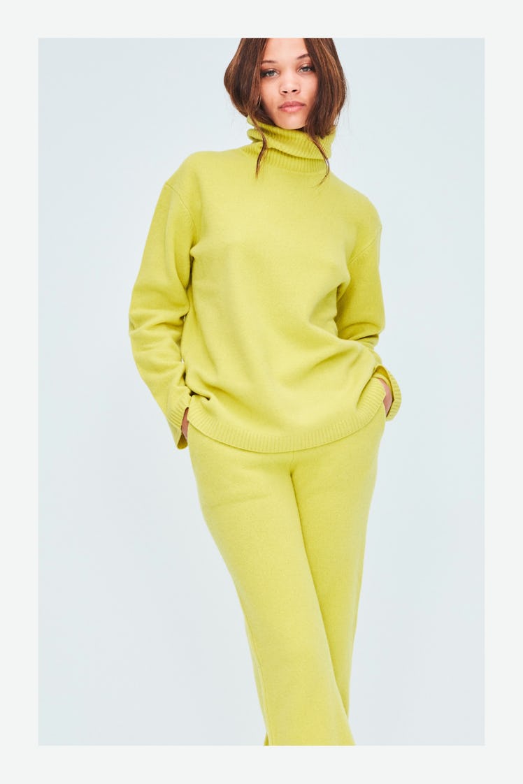 A model in a yellow turtleneck and matching pants by Victor Glemaud