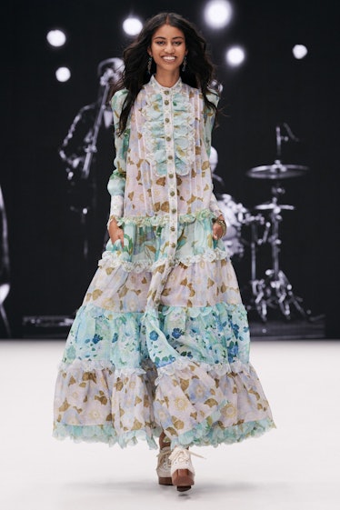 A model in a semi-sheer long dress with ruffles by Zimmermann