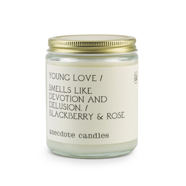A Young Love Anecdote Candle that says "smell like devotion and delusion/ blackberry & rose" on it 