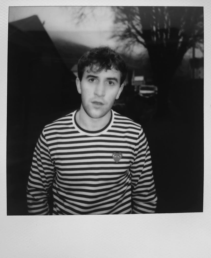 A black and white polaroid of Callum Scott in a striped shirt