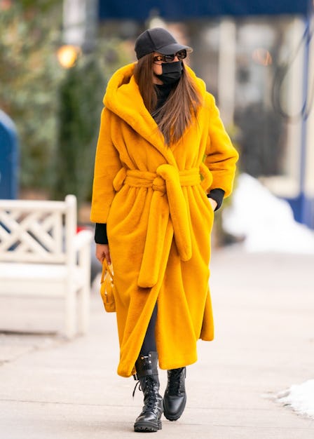 Irina Shayk walking in an orange coat