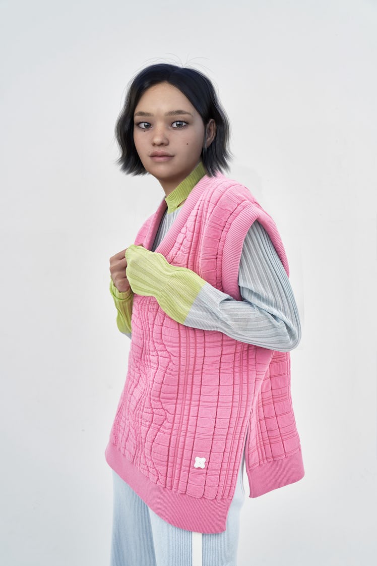 PH5's CGI model AMA in a pink vest and grey and green sweater 