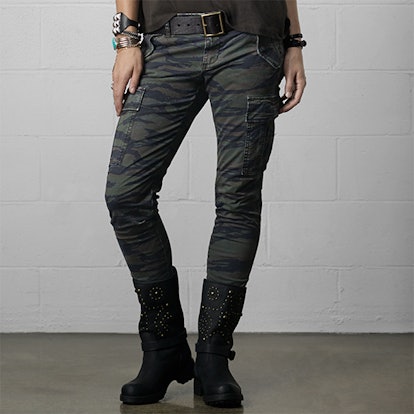 A model standing while posing in skinny camo cargo pants from Denim & Supply 
