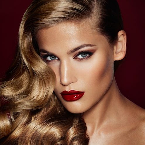 A model with red lipstick and dark eyeshadow from Charlotte Tilbury