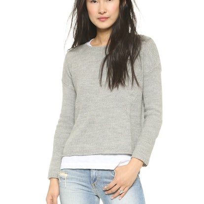 A woman posing in an overzied boyfriend sweater