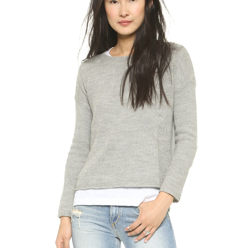 A woman posing in an overzied boyfriend sweater