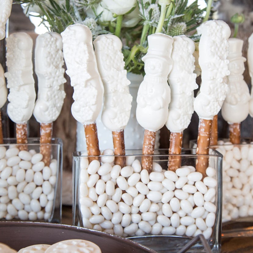 White candy shaped like snowmen on a stick as a table décor