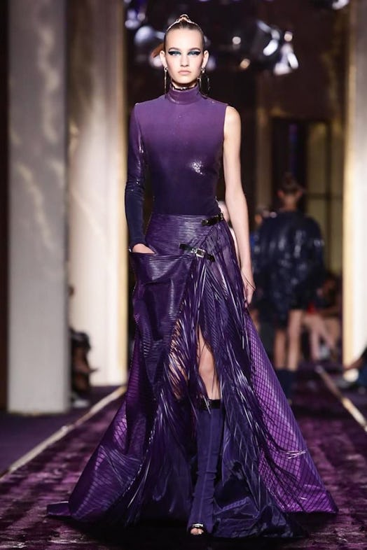 A woman walking in a purple gown