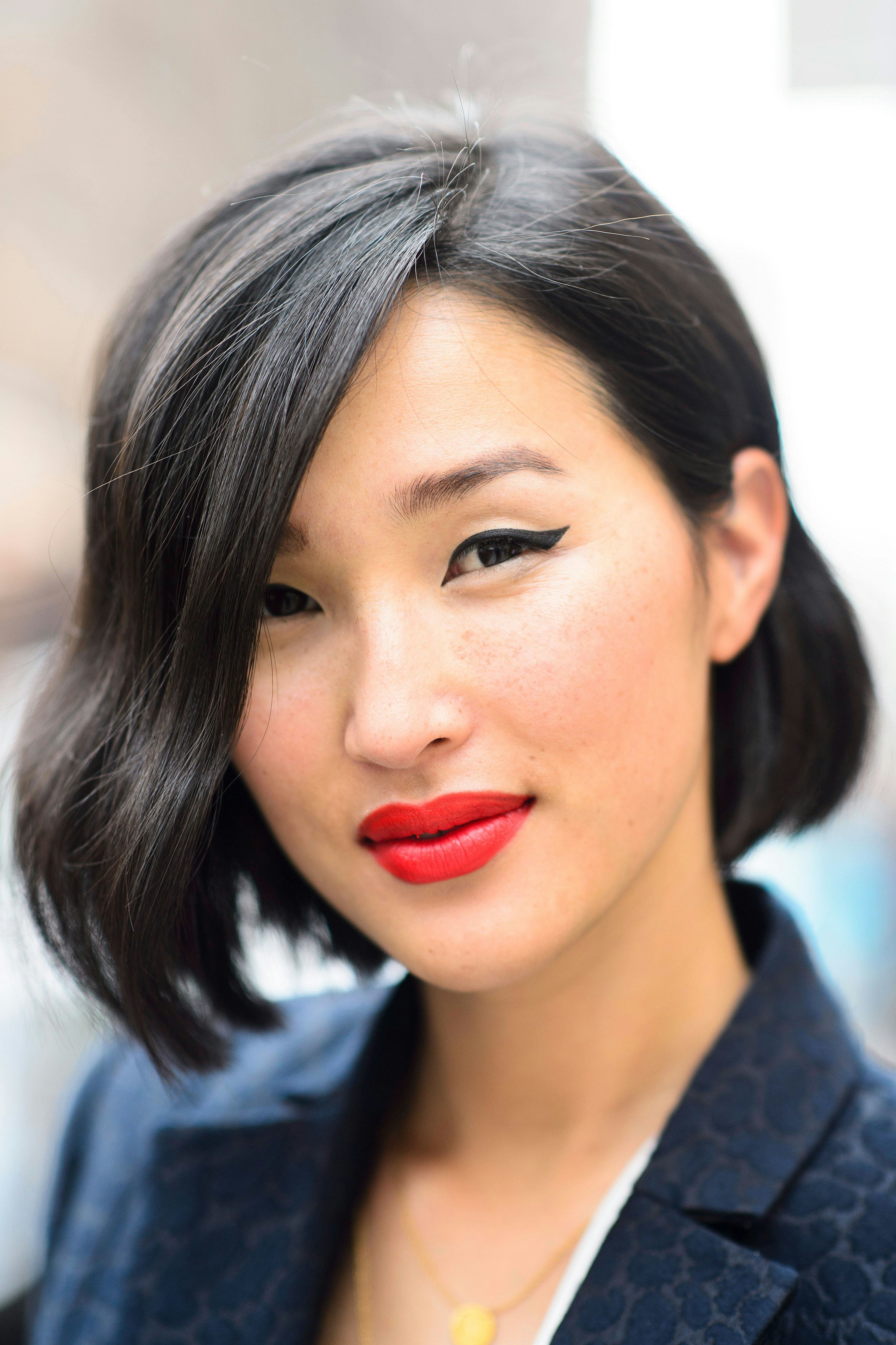 A model with winged eyeliner and red lip gloss that isn't sticky