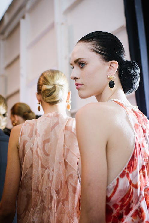 A young lady with black hair tied in a bun at a party