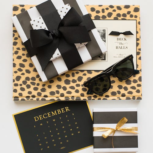 Gifts wrapped in stripy and leopard-print paper alone with a card and a December calendar