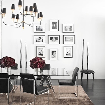 A dining table in a room with white walls 