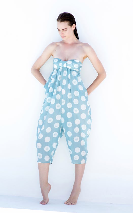 A model posing in a light blue strapless playsuit with white dots