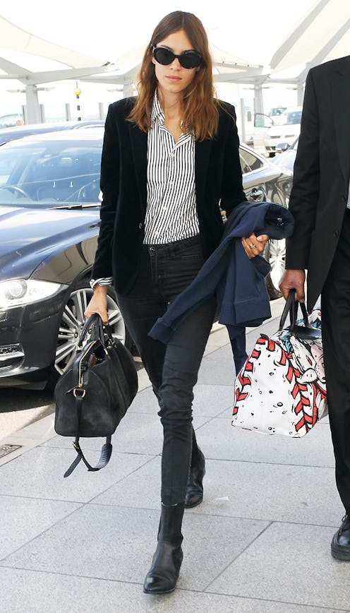 A woman wearing a black suit and basic shirt as one of the outfits you keep forgetting to pack in yo...