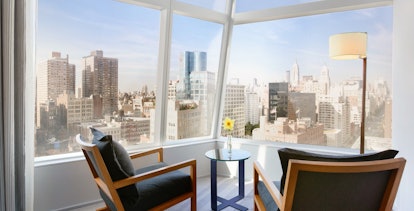 Dagmar chairs and a diamond lighting Lancaster chrome floor lamp in a room next to a window