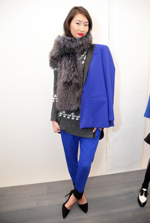 A model backstage wearing a blue suit and Banana Republic's faux fur scarf