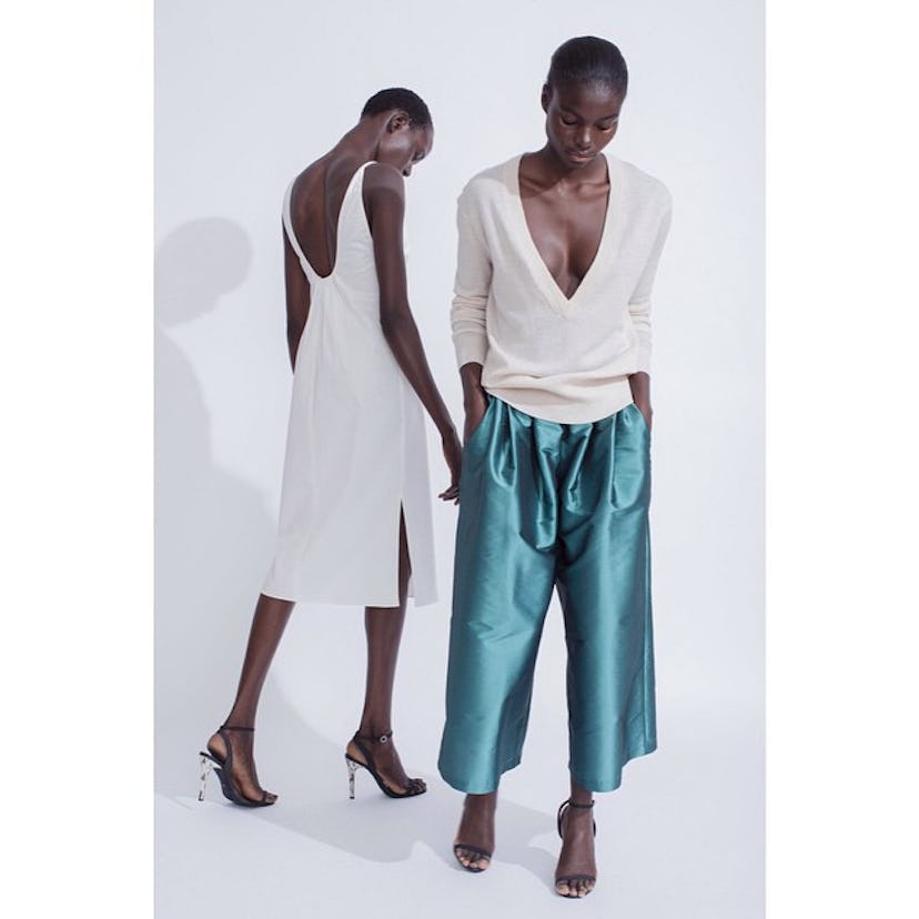 Models posing in Toteme's loose-cut sportswear in luxe fabrics and subdued hues