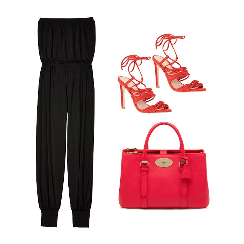 A black jumpsuit, a red bag, and red heels on a white background 