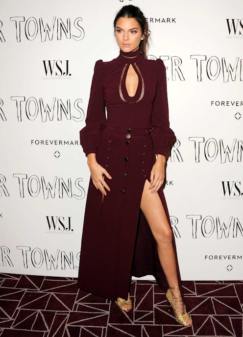 Kendall Jenner in a black deceptively sexy 70s blouse and a black skirt at a red carpet event