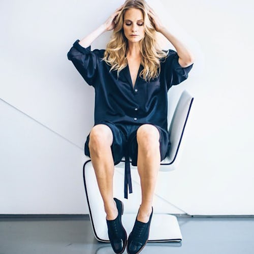 A model posing touching her freshly blown out hair