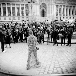 Strike A Pose street-style photographer standing in front of a large crowd of people in black and wh...