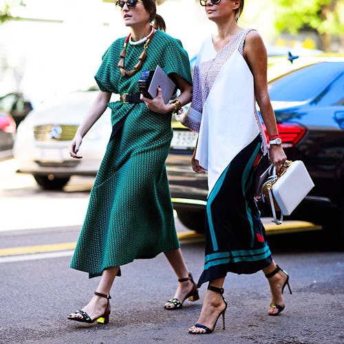 Two ladies walking in green and white street-style dresses from the Milano Fashion Week