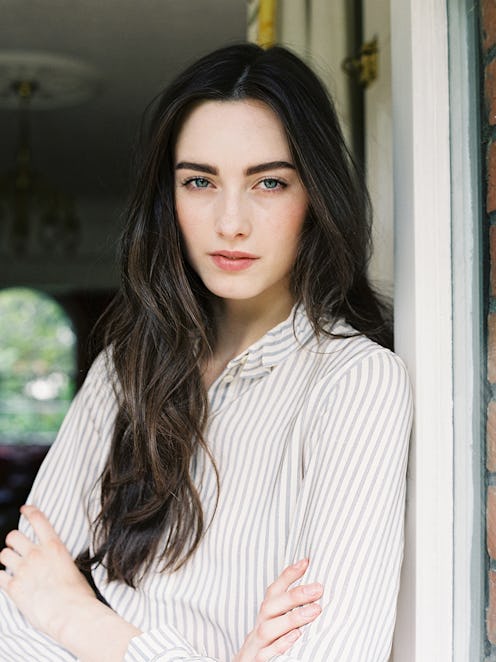 A brunette woman in a white-grey striped shirt with crossed arms who knows hot save dry hairs from S...