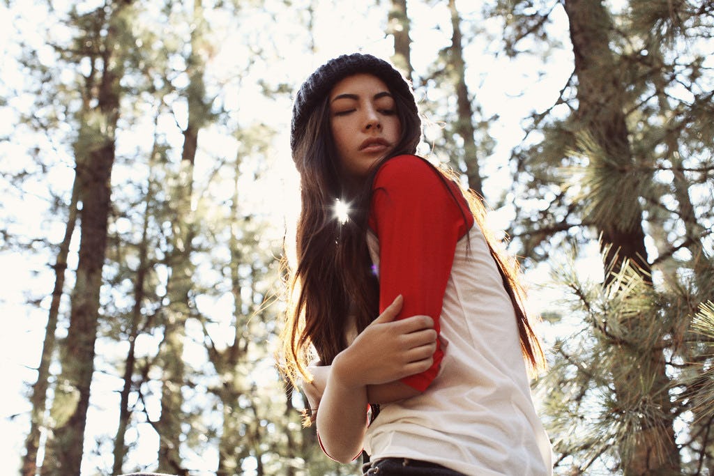 A girl posing in the woods on a glamping getaway