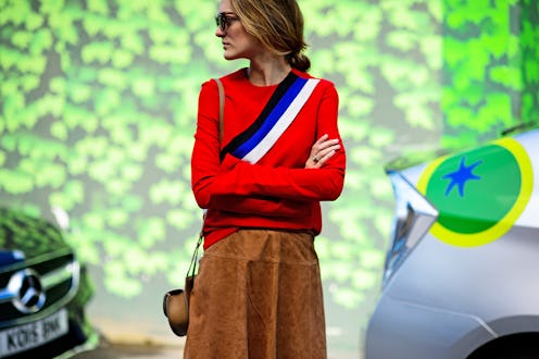 A woman posing in a caramel suede fall skirt