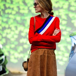 A woman posing in a caramel suede fall skirt
