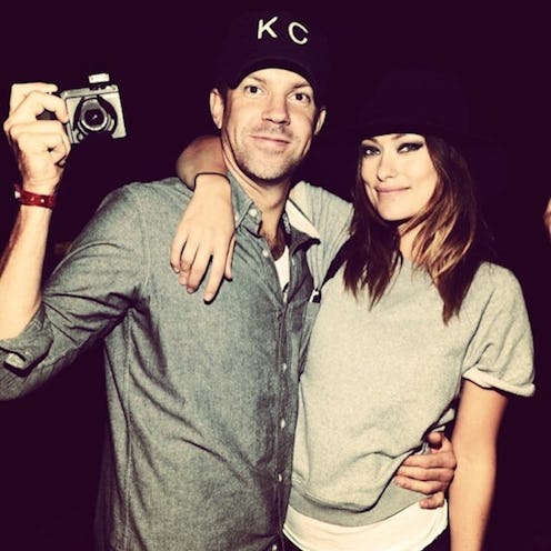 Olivia Wilde hugging Jason Sudeikis while he holds a camera