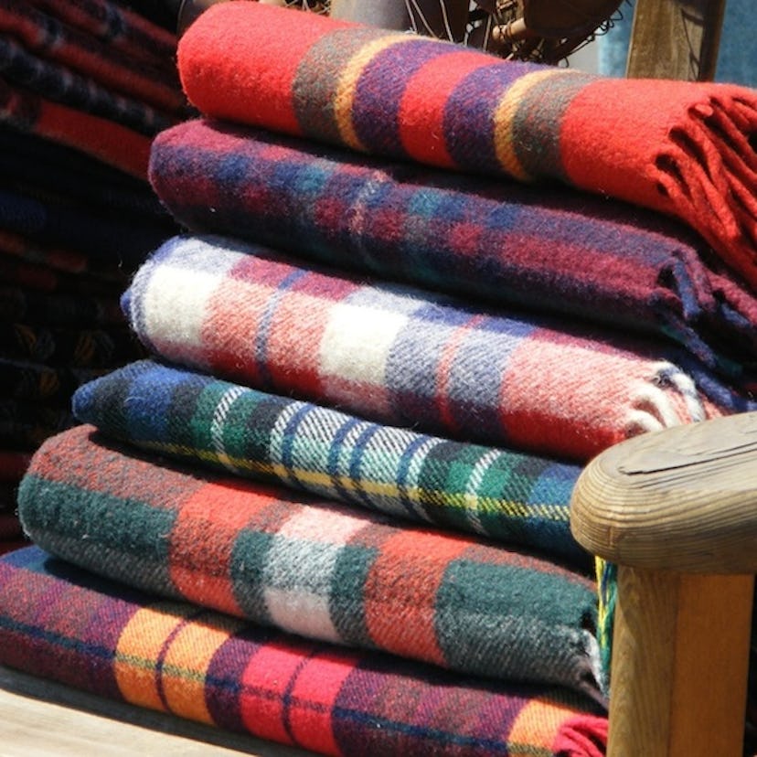 A stack of tartan blankets prepared for hosting a great football party