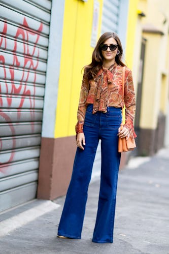 A woman in a ruffled blouse and high-waisted jeans for the office