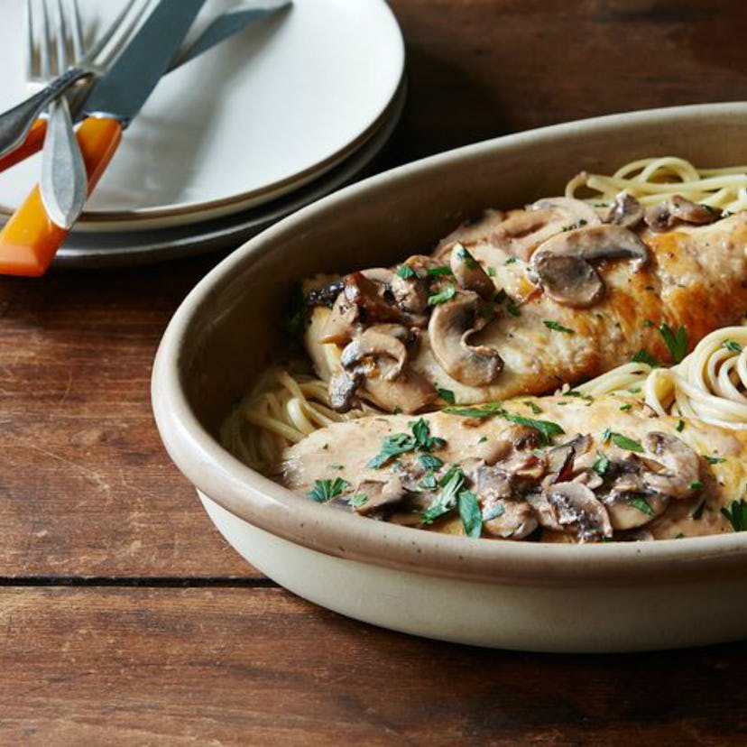 A slow-cooker meal with mushrooms, spaghetti, and chicken served in a plate