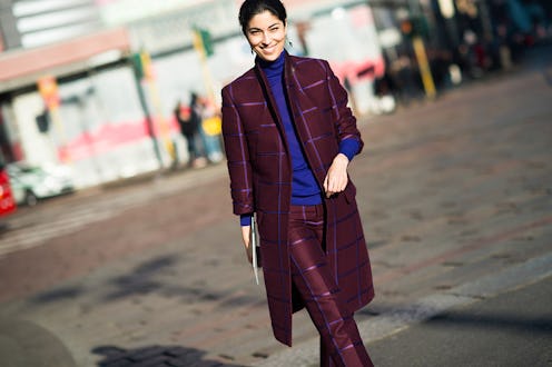 Woman wears geek-chic burgundy-and-blue checkered suit paired with a blue turtleneck.