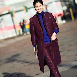 Woman wears geek-chic burgundy-and-blue checkered suit paired with a blue turtleneck.