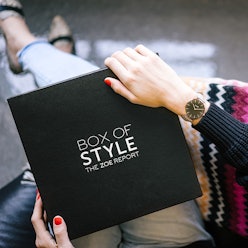 A woman holding the box of style from the zoe report on her lap