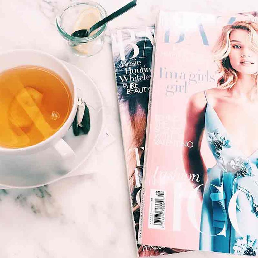 Two magazines next to a cup of tea 