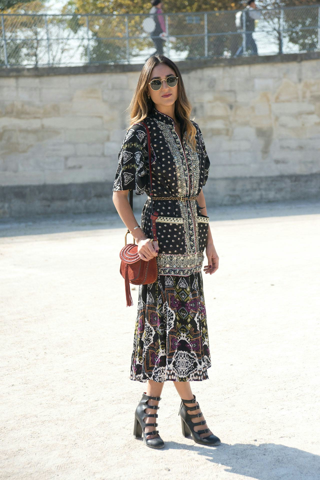 A woman posing in a black dress 