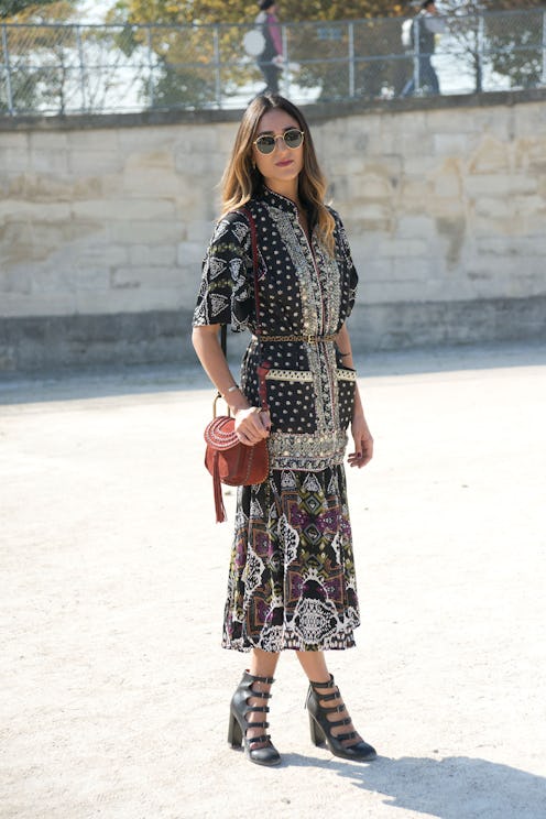 A woman posing in a black dress