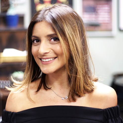 A brunette woman with a perfect lob