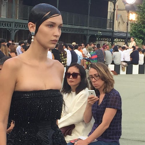 Bella Hadid walking the runway in a black sparkly top and slicked hair at the Givenchy show in Paris...