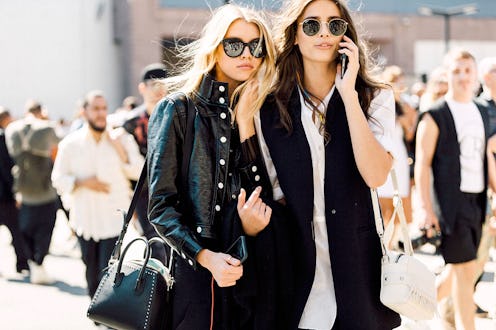 Two models walking down the street showing off their trendy nail polish