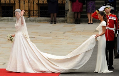 A maid of honor holding Kate Middleton's gown during the royal wedding