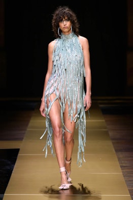A model wearing Atelier Versace fringed dress from their Fall 2016 Couture Show