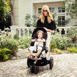 A woman behind a luxe baby gear stroller by Rachel Zoe