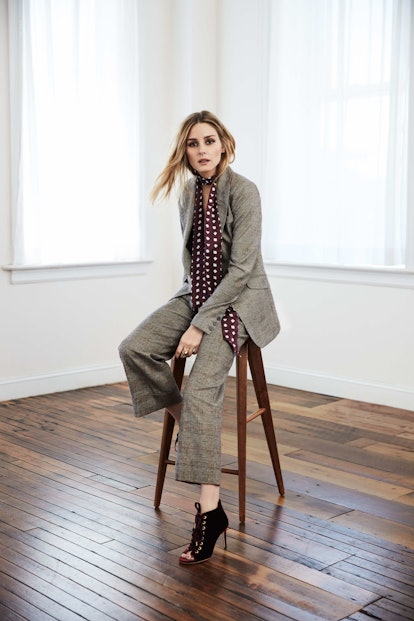 Olivia Palermo in a grey suit with a burgundy-white polka-dot scarf