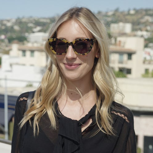 A blonde woman who is a fashion girl with a black top and leopard print sunglasses 