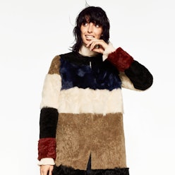 A model posing in Zara's leather patchwork coat in white, dark blue, black, burgundy and beige