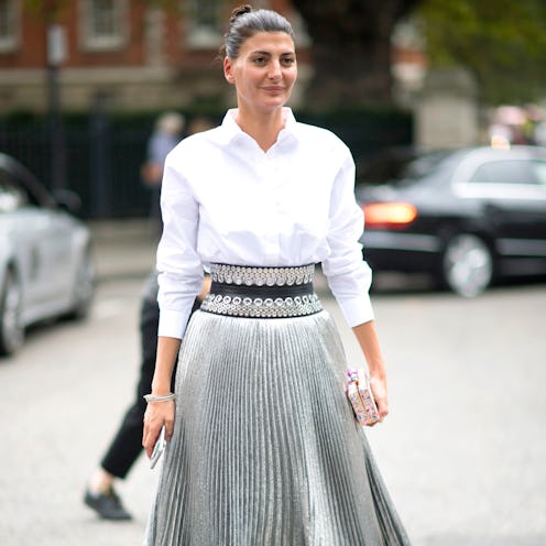 A brunette woman in a white shirt and a silver perfect holiday party skirt